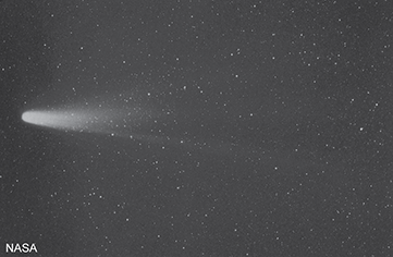 The comet has a broad diffuse tail that spreads outward from the head of the comet becoming wider as it stretches away from the head.